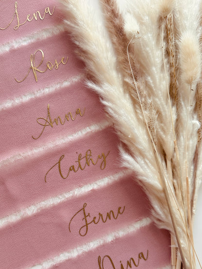 Blush pink chiffon ribbon with frayed edge with gold vinyl names